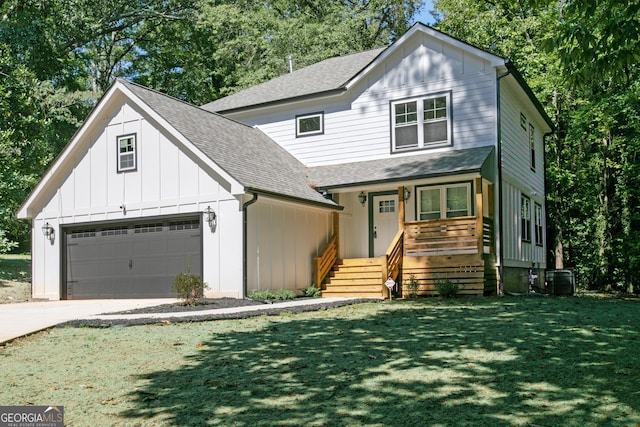 view of front of home featuring central AC, a front lawn, and a garage