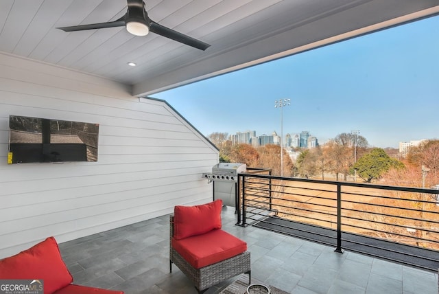 balcony with ceiling fan and a view of city