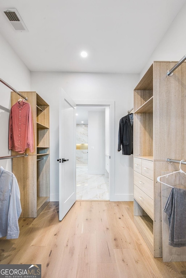 spacious closet with visible vents and light wood-style floors