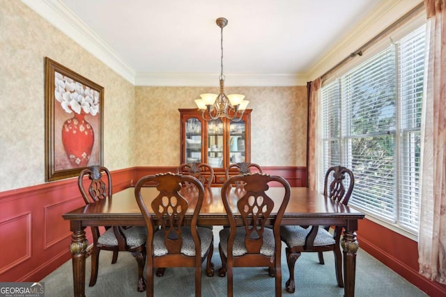 dining room with carpet flooring, a chandelier, and ornamental molding