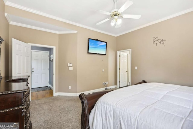 carpeted bedroom featuring ceiling fan and crown molding