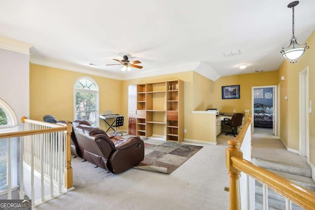 living room with ceiling fan, crown molding, and light colored carpet