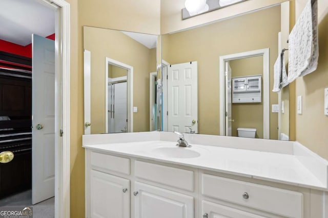 bathroom featuring vanity and toilet