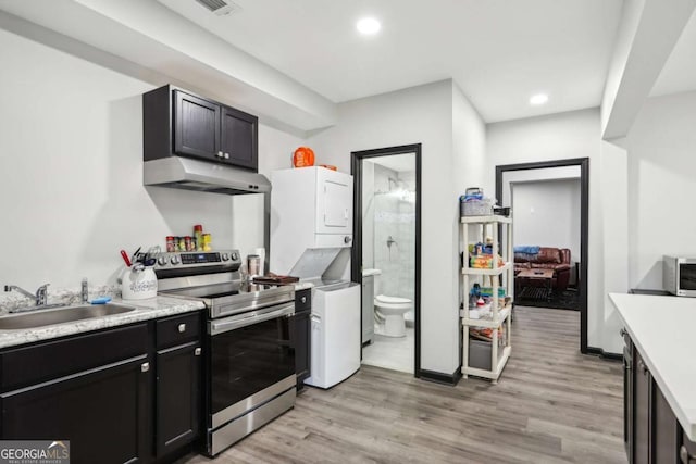 kitchen featuring light wood-type flooring, stainless steel range with electric stovetop, and sink