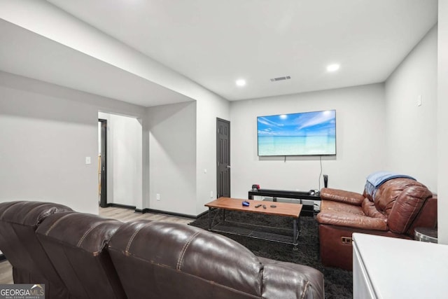 home theater room featuring light hardwood / wood-style floors