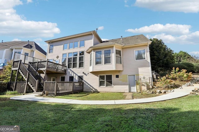 back of house with a yard and a wooden deck