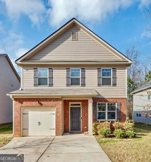 11945 Lovejoy Crossing Way, Hampton, GA 30228 - view of front of property featuring brick siding, an attached garage, and concrete driveway