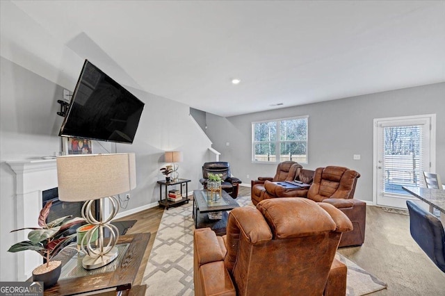 living room featuring plenty of natural light and light hardwood / wood-style floors