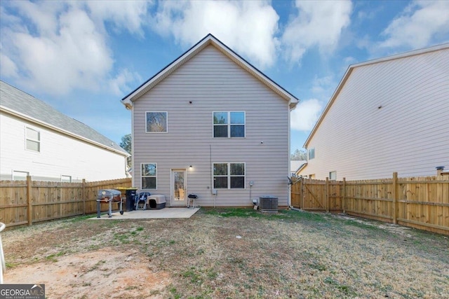 back of house featuring cooling unit, a patio area, and a lawn