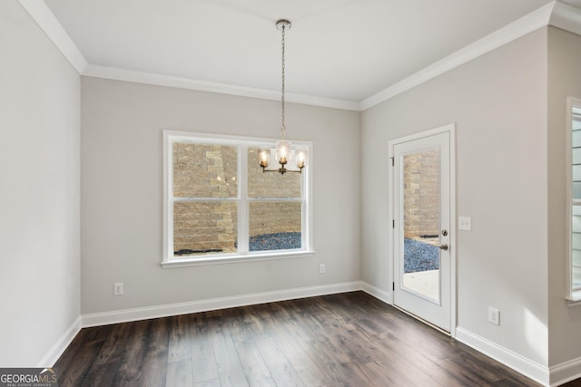 unfurnished dining area featuring ornamental molding, plenty of natural light, and a chandelier