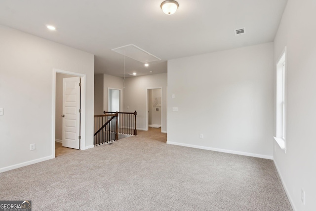 unfurnished room with light carpet