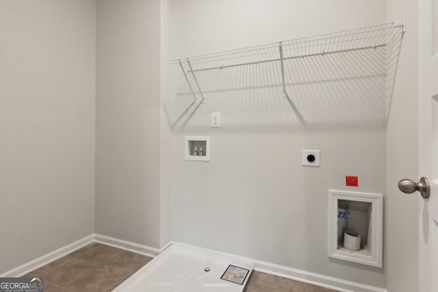 laundry area featuring washer hookup, dark tile patterned flooring, and hookup for an electric dryer