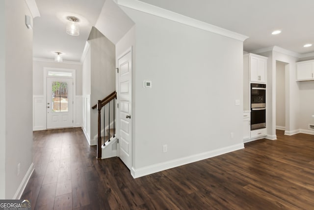 entrance foyer with crown molding and dark wood-type flooring