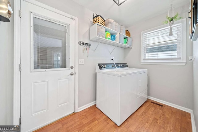 washroom featuring light wood-type flooring and washing machine and clothes dryer