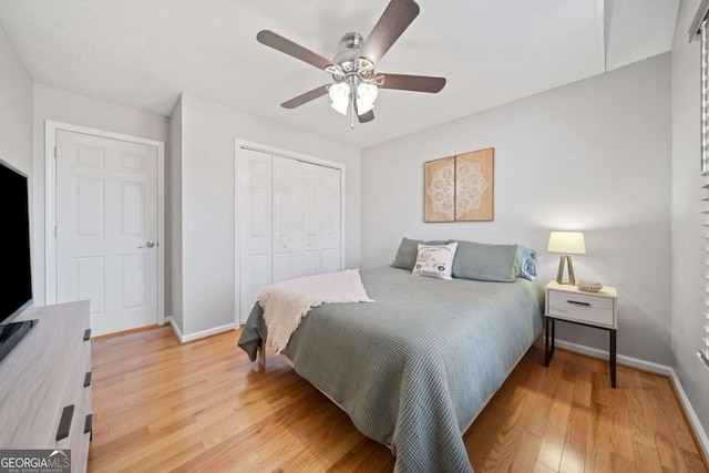 bedroom with ceiling fan, a closet, and wood-type flooring