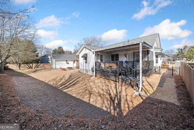 rear view of property featuring a porch