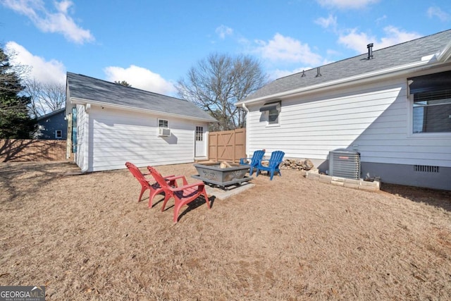 rear view of house with a fire pit and central AC unit