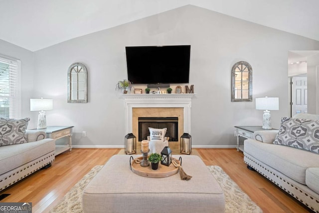 living room with hardwood / wood-style floors and vaulted ceiling