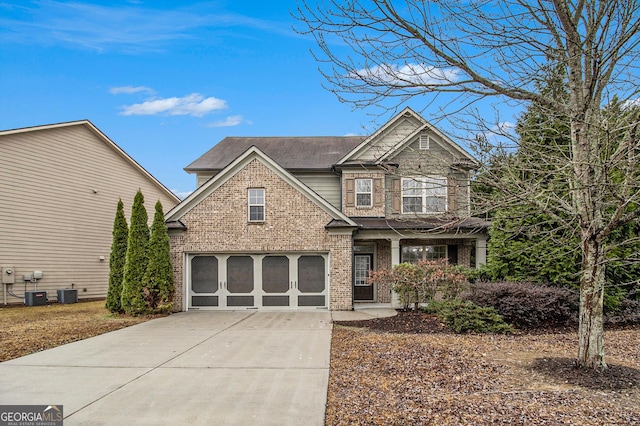 view of front of property featuring central AC unit and a garage