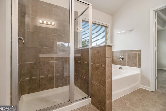 bathroom featuring tile patterned floors and separate shower and tub