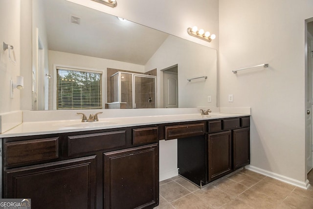 bathroom with tile patterned floors, vanity, a shower with shower door, and lofted ceiling