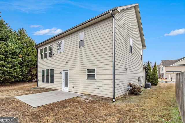 rear view of property with a patio area and central air condition unit