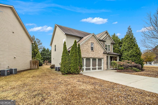 view of side of property with central AC and a garage