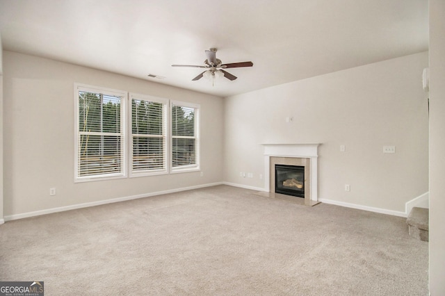 unfurnished living room with light carpet and ceiling fan