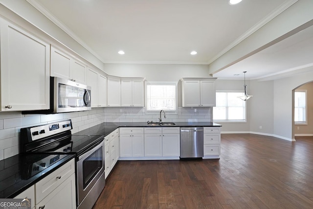 kitchen featuring sink, white cabinets, tasteful backsplash, and stainless steel appliances