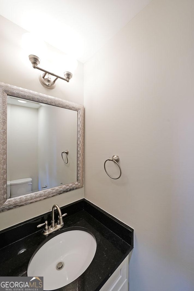 bathroom featuring vanity and toilet