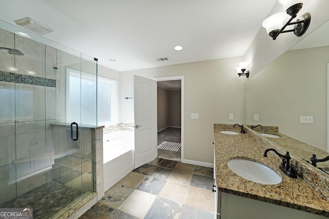 bathroom with a healthy amount of sunlight, plus walk in shower, and vanity