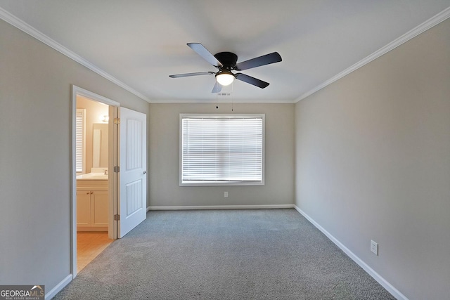 unfurnished bedroom featuring light carpet, ensuite bath, ceiling fan, and ornamental molding