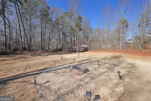 view of yard with a fire pit