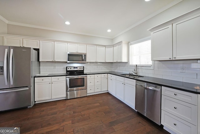 kitchen with sink, stainless steel appliances, white cabinets, and dark wood-type flooring