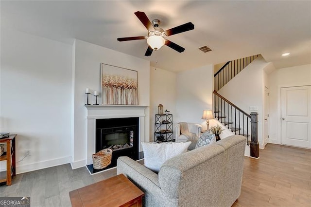 living room featuring ceiling fan and wood-type flooring