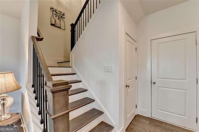 stairs featuring hardwood / wood-style flooring