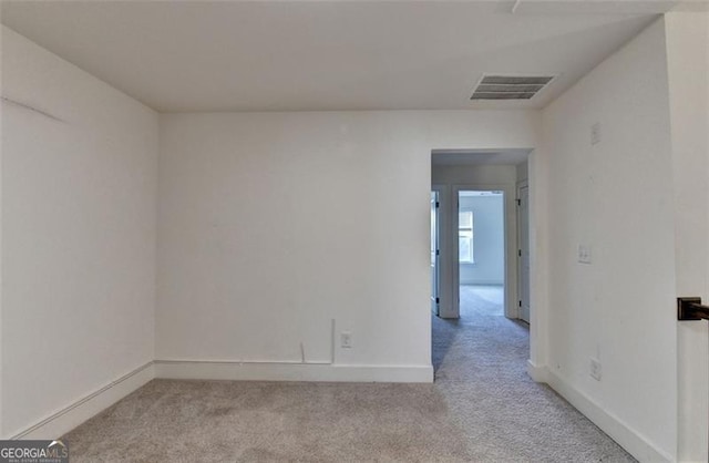 empty room featuring light colored carpet