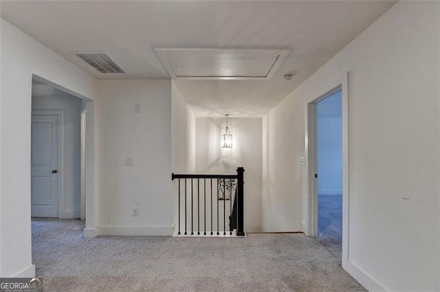 hall featuring light colored carpet