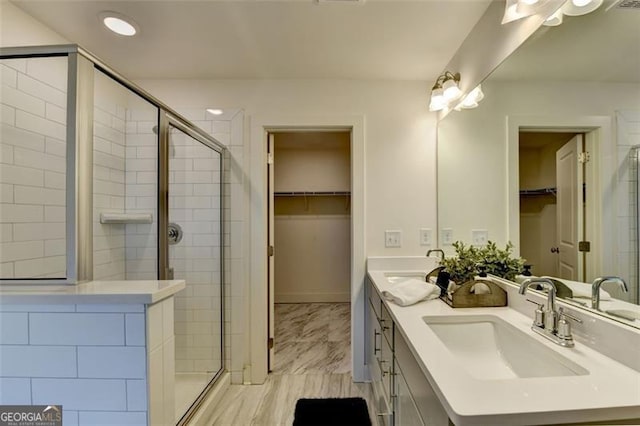 bathroom featuring vanity and an enclosed shower