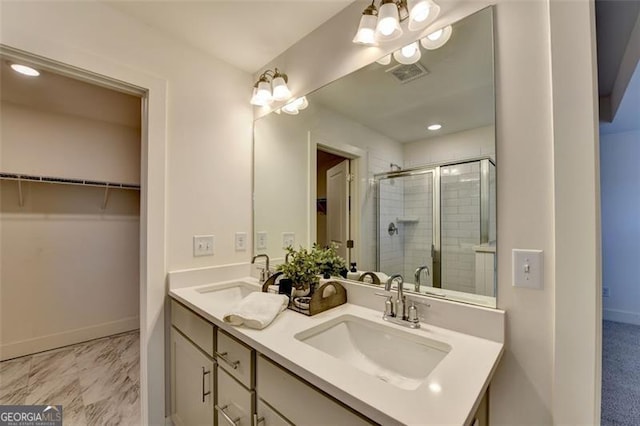 bathroom with vanity and a shower with shower door