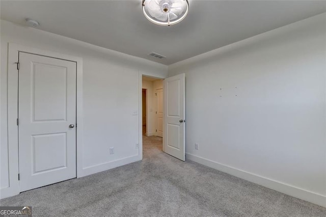 unfurnished bedroom with light colored carpet