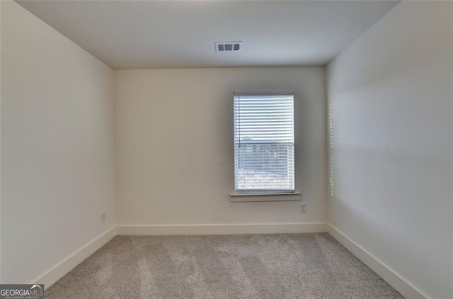 carpeted spare room featuring plenty of natural light