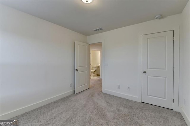 unfurnished bedroom featuring light colored carpet