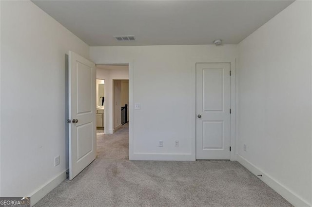 unfurnished bedroom featuring light colored carpet