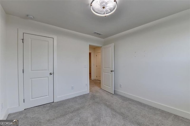 unfurnished bedroom with light colored carpet