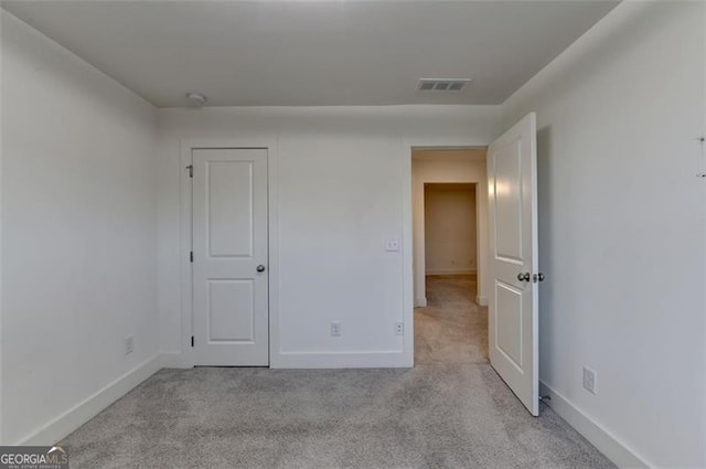 unfurnished bedroom featuring light carpet