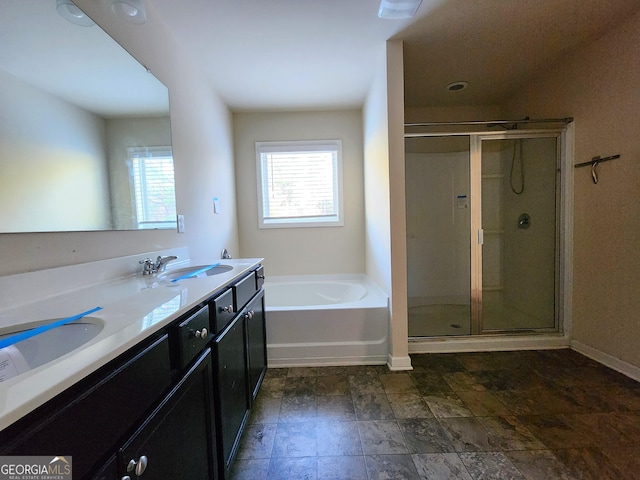 bathroom featuring vanity and independent shower and bath