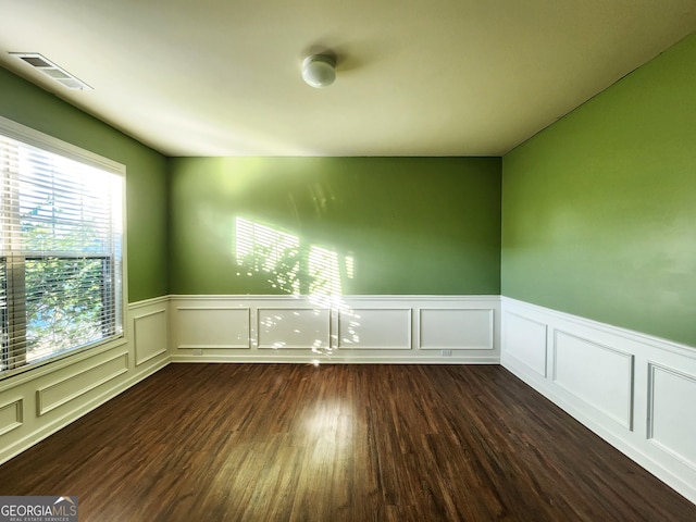 spare room featuring dark hardwood / wood-style flooring