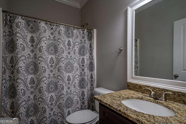 bathroom featuring vanity, toilet, and crown molding