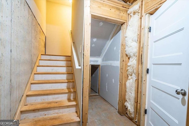 stairway featuring concrete flooring